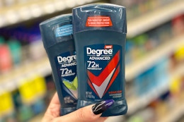 two degree deodorant sticks held in hand