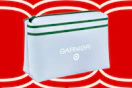 White Garnier makeup bag with green stripe and Target logo, on a red background