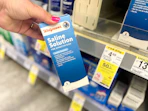 hand holding saline solution in walgreens