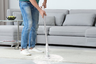person using spin scrubber on floor