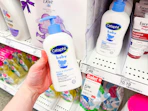holding a bottle of cetaphil baby wash & shampoo in front of a target shelf