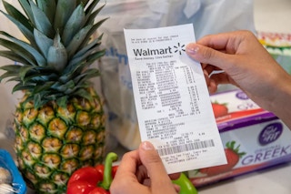 someone looking at a receipt from walmart