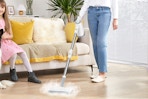 woman using steam mop in living room