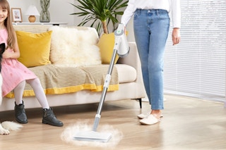 woman using steam mop in living room