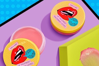 two lip balm tins on a blue, purple, and green background