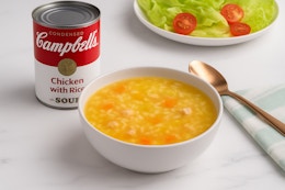 chicken and rice soup being served in a bowl
