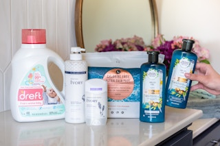 Natural brand name products sitting on a bathroom counter.