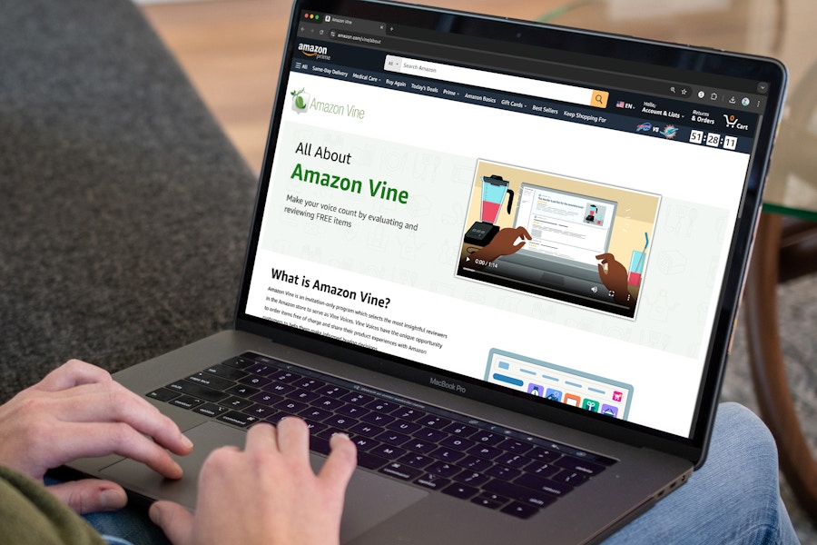 A person using a laptop to look at the Amazon website's page about Amazon Vine.