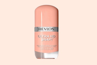 a pink nail polish bottle on a peach background