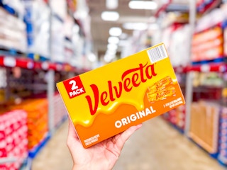 hand holding a box of velveeta cheese loafs
