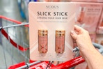 hand holding a pack of nexxus slick sticks