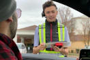 a teenager taking someone's order in the drive through at chick-fil-a