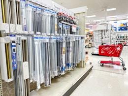 curtain rods sitting on a shelf with a target cart parked in front