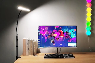 desk lamp shining over computer area