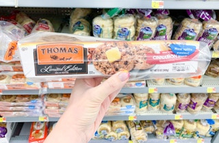 thomas' limited edition english mufffins held in front of walmart shelf