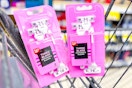 2 packs of pink disposable razors in a cart