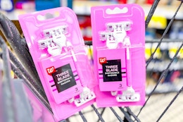 2 packs of pink disposable razors in a cart