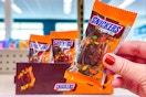 hand holding snickers pumpkins