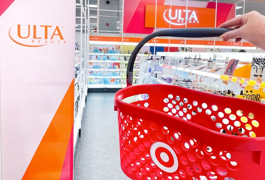a target hand basket being held in front of ulta sign in the ulta section inside target