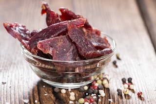 A bowl of homemade beef jerky on a table