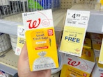 hand holding walgreens brand trash bags pack