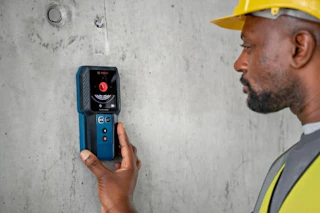 a man using a bosch wall scanner
