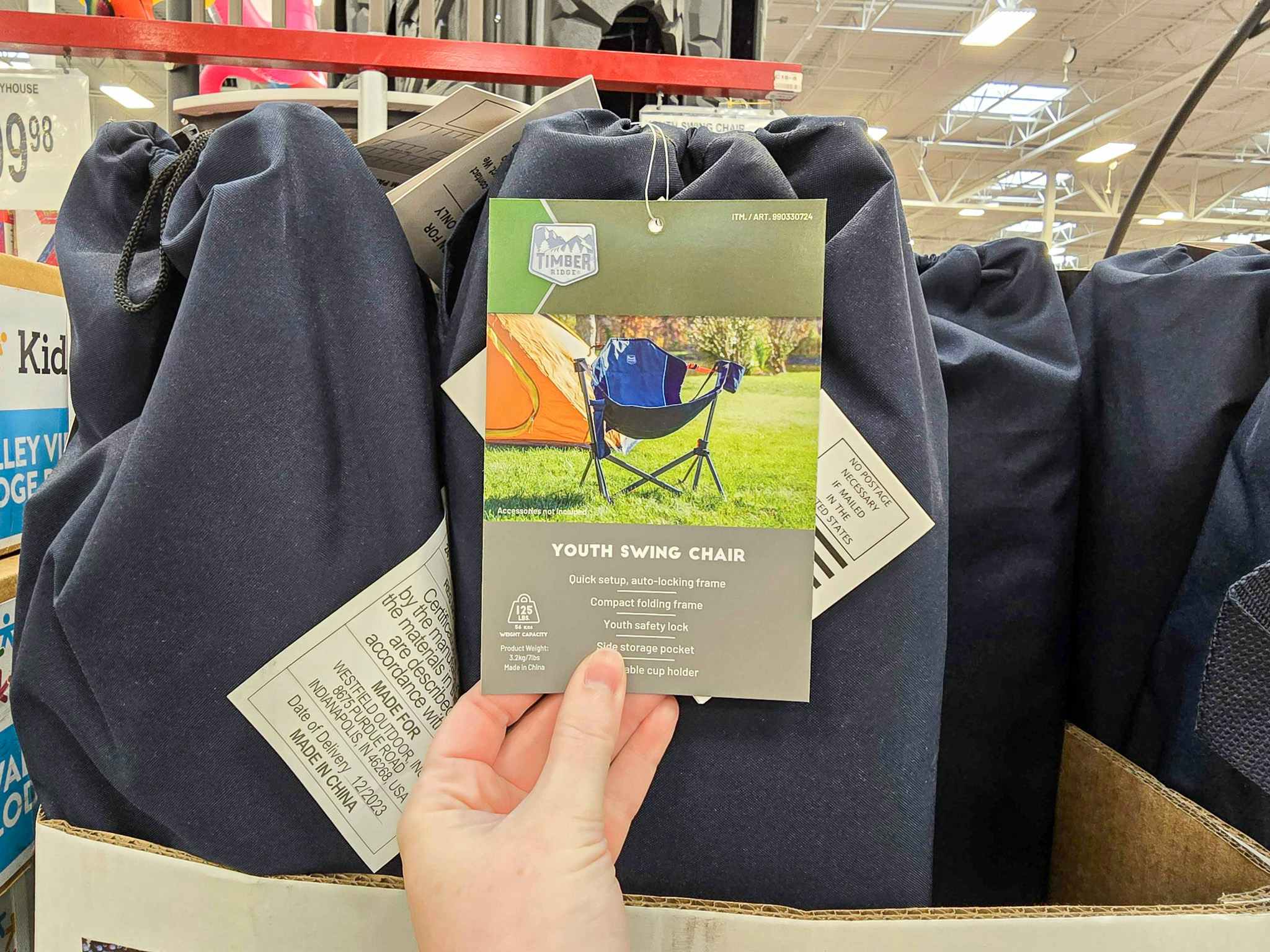 person holding a tag on a swinging camp chair