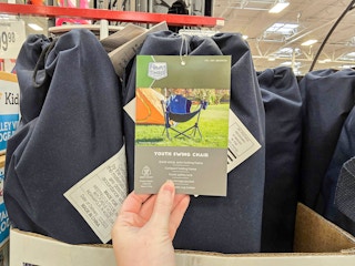 person holding a tag on a swinging camp chair