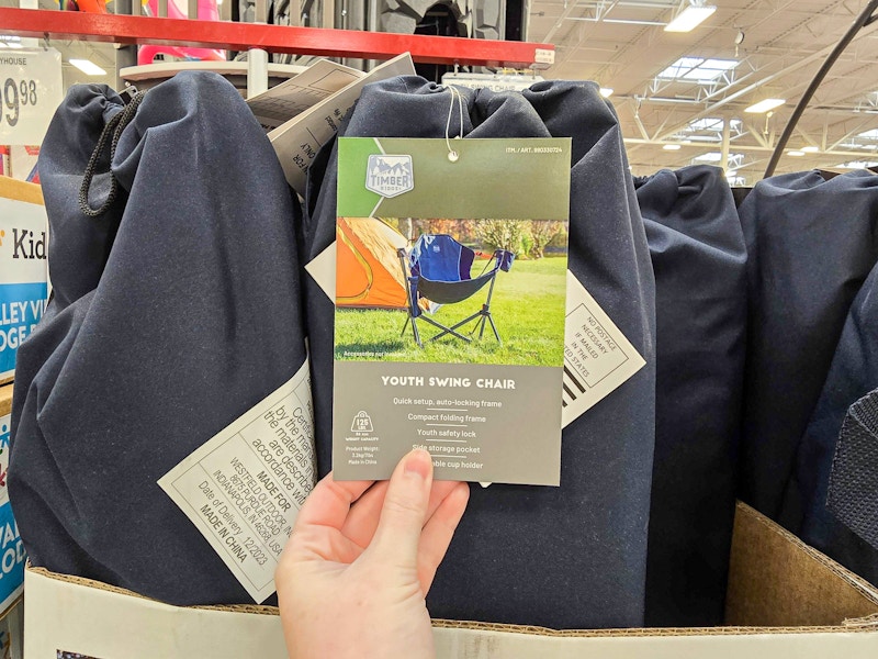 person holding a tag on a swinging camp chair