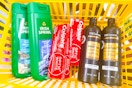 irish spring, colgate, tresemme products in a yellow basket