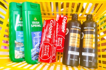 irish spring, colgate, tresemme products in a yellow basket