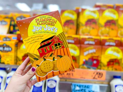 hand holding a box of trader joes pumpkin cookies