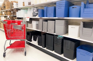 An aisle of decorative storage baskets with a Target cart and Target sale sign