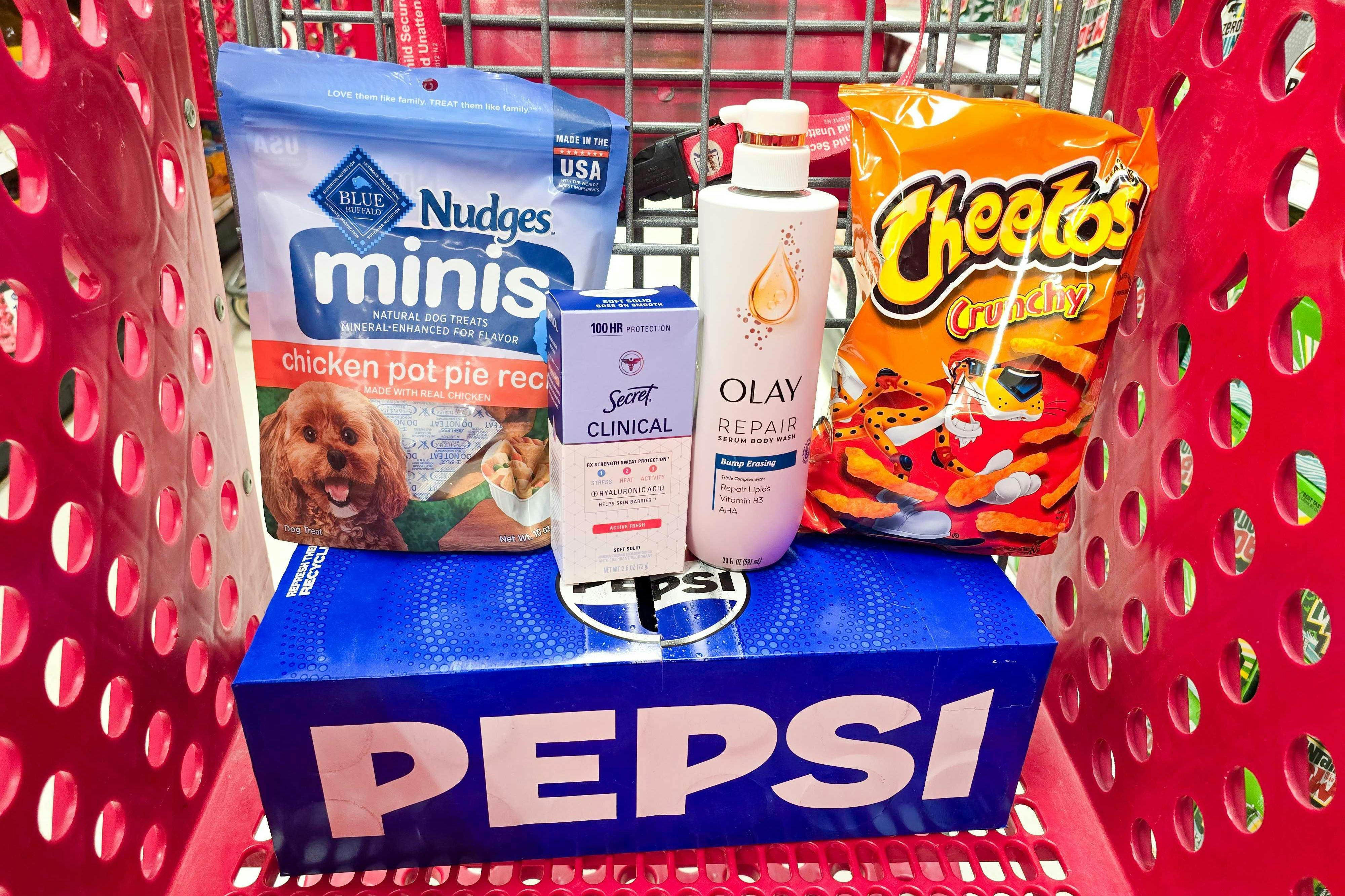 pepsi soda, nudges dog treats, secret deodorant, olay body wash, and cheetos in a cart
