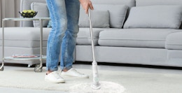 a person using an electric scrubber on the floor