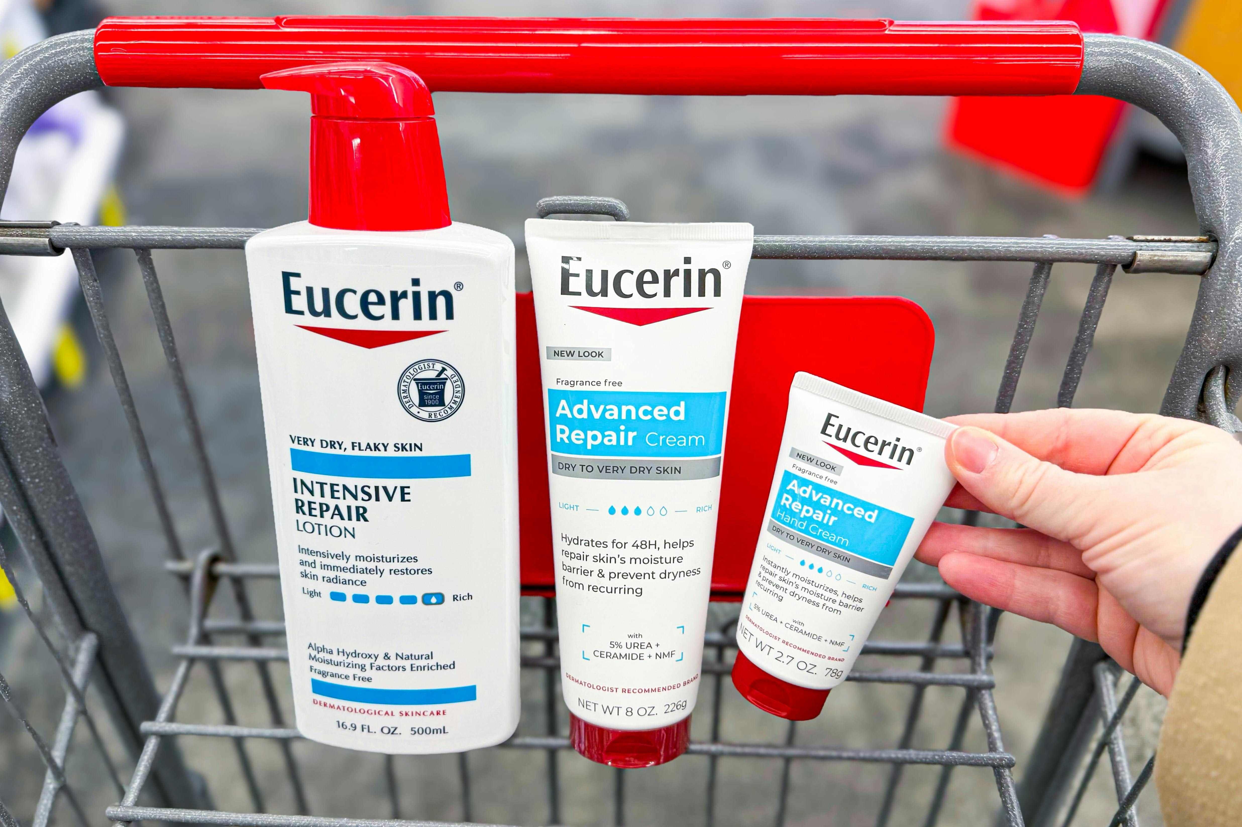 hand grabbing eucerin lotion products in a shopping cart