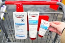 hand grabbing eucerin lotion products in a shopping cart