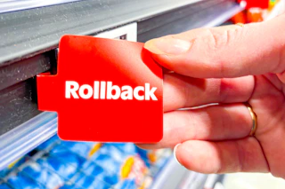 hand holding a red Walmart Rollbacks tag