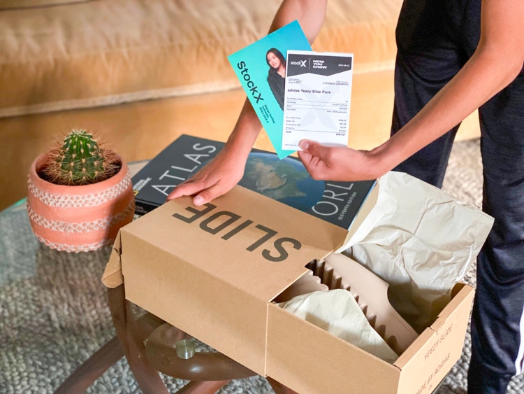 Person holding receipts from a StockX shoe delivery box