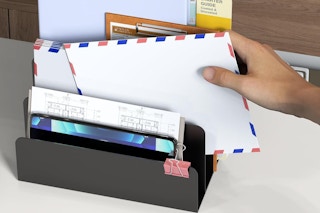 a woman putting mail in an organizer