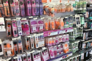 Real Techniques brushes and sponges in a store aisle.