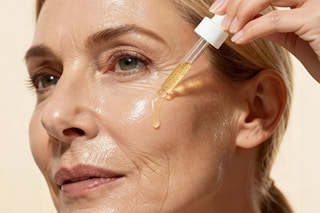 woman applying serum to face