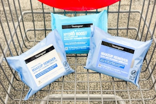 three packs of neutrogena makeup wipes in a shopping cart
