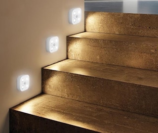 the lights on the wall next to steps