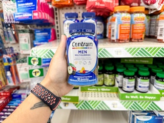 hand holding centrum vitamins