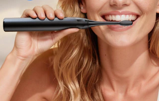 a person using an electric toothbrush 