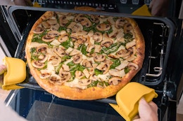 Someone baking a Papa Murphy's pizza in their oven