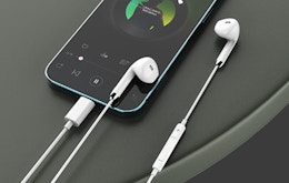 wired headphones next to a phone