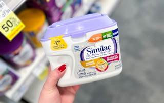 person holding container of Similac Pro Total Comfort formula