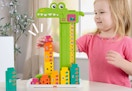 child playing with the Fisher Price stacking and counting alligator